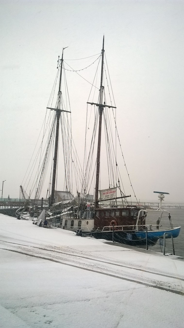 Tall ship, The Albatross in snow, snow on quay, Wells-next-the-sea harbour